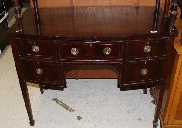 A bow fronted mahogany sideboard, the plain top above three drawers and a cupboard door with