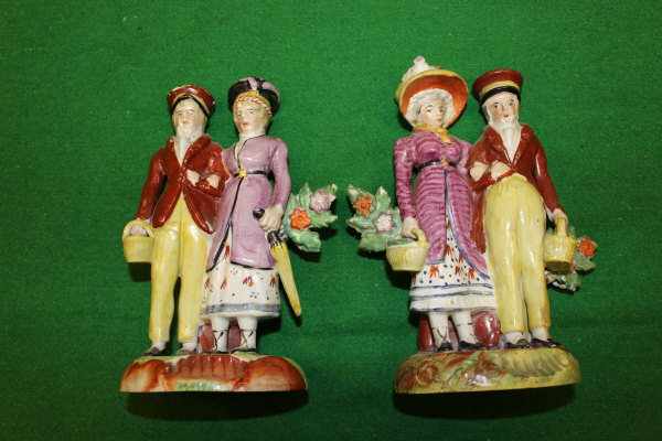 A pair of early 19th Century Staffordshire Walton type figures, each depicting a couple standing