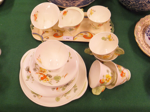 A Royal Doulton "Nasturtium" pattern tea service decorated with nasturtium flowers and with flower