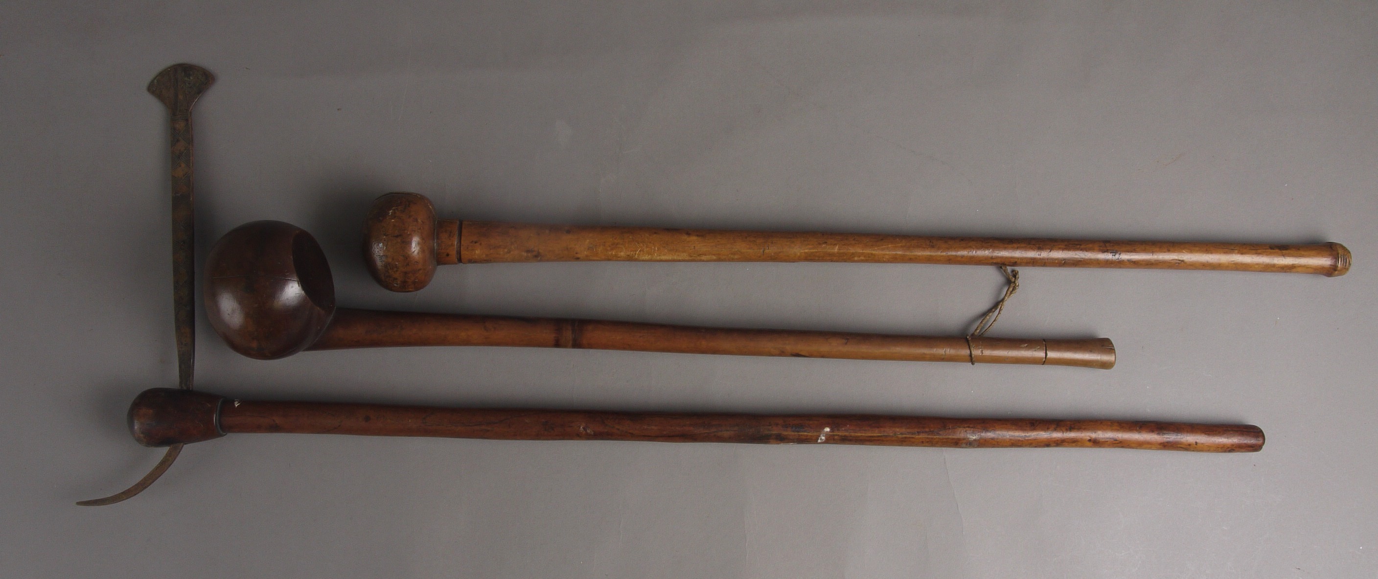 TWO 19TH CENTURY AFRICAN HARDWOOD KNOBKERRIES, with plain tapering shafts, 60cm and 67cm long