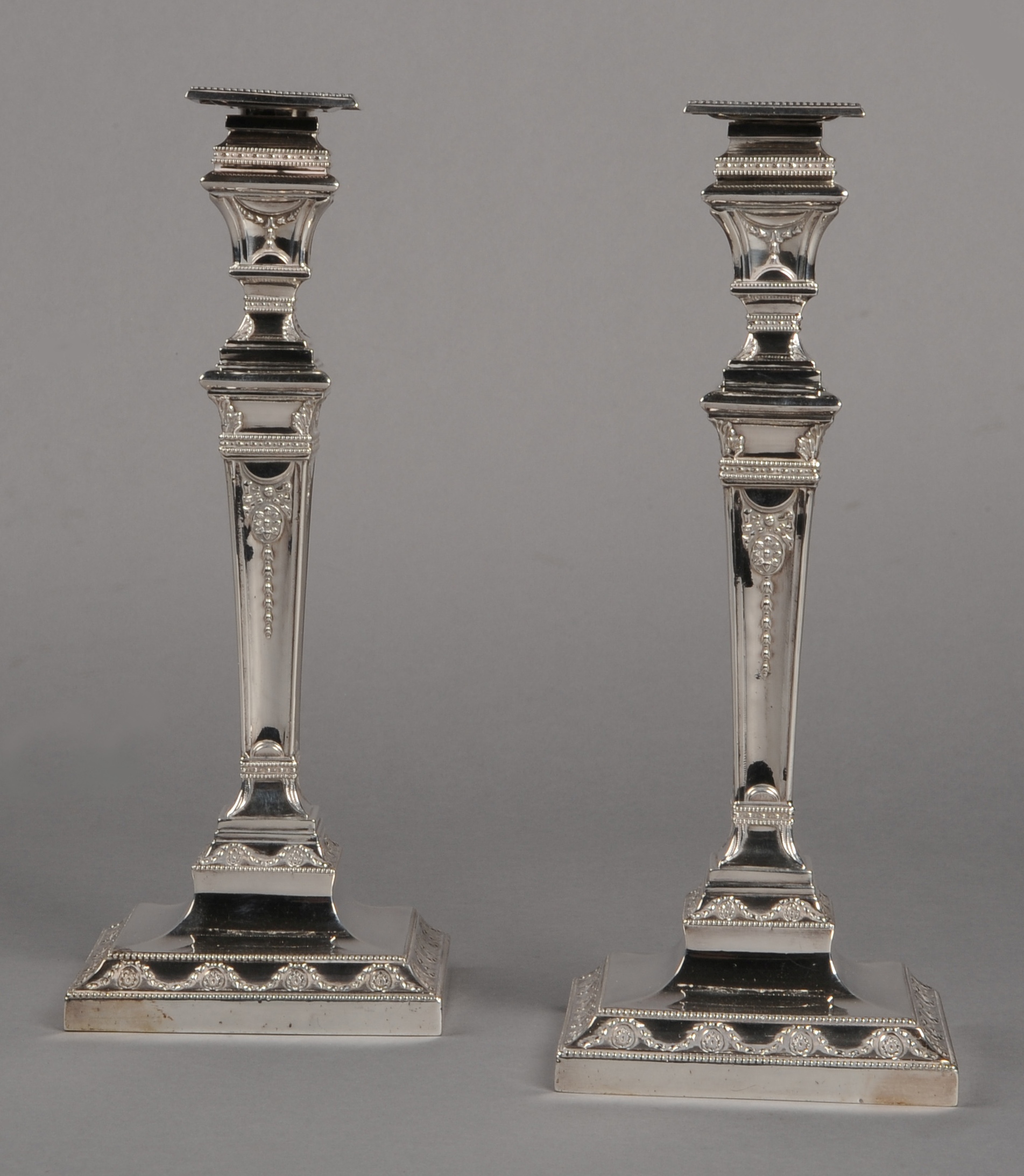 A PAIR OF VICTORIAN SILVER CANDLESTICKS, Horace Woodward & Co, London 1876, Adam style, each with