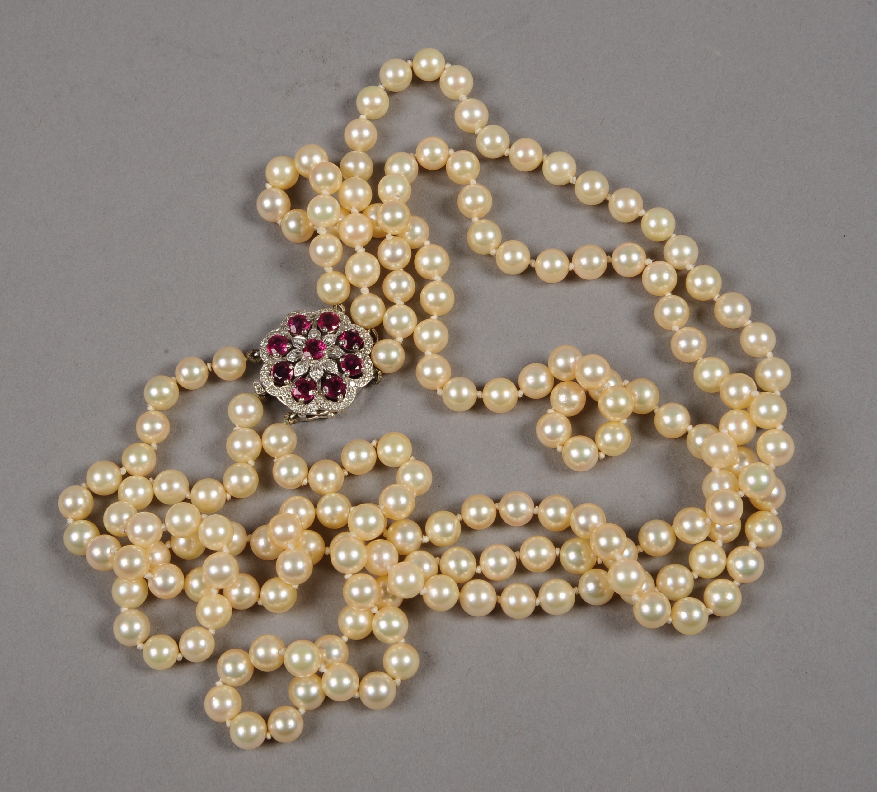 A CULTURED PEARL NECKLACE, of three rows of 6.5mm pearls, the 9ct white gold snap of circular