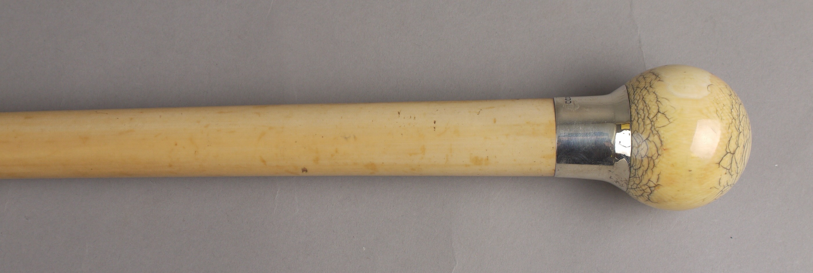 AN EARLY 20TH CENTURY MALACCA WALKING CANE, by J. Howell & Co, with ivory ball knop and silver