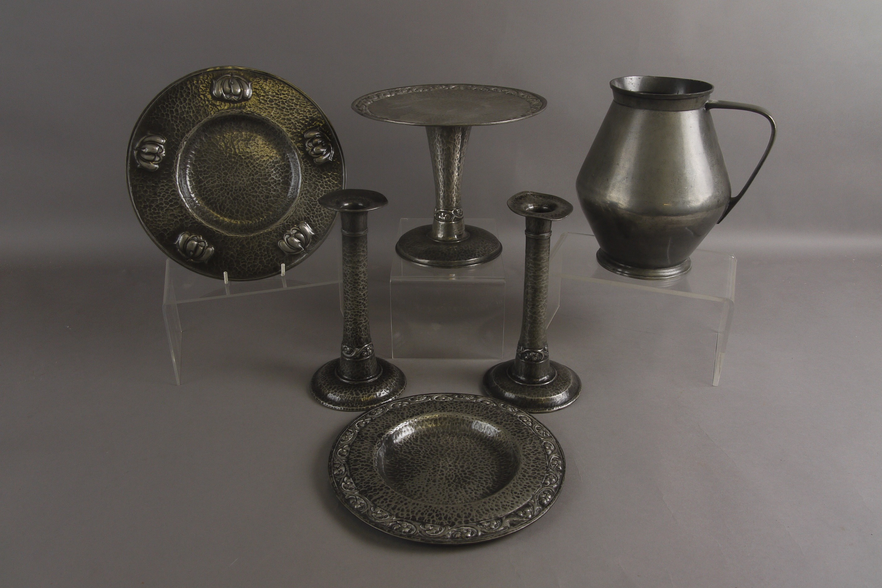 A PAIR OF EARLY 20TH CENTURY PLANISHED 'ENGLISH PEWTER' CANDLESTICKS, a matching tazza and plate,
