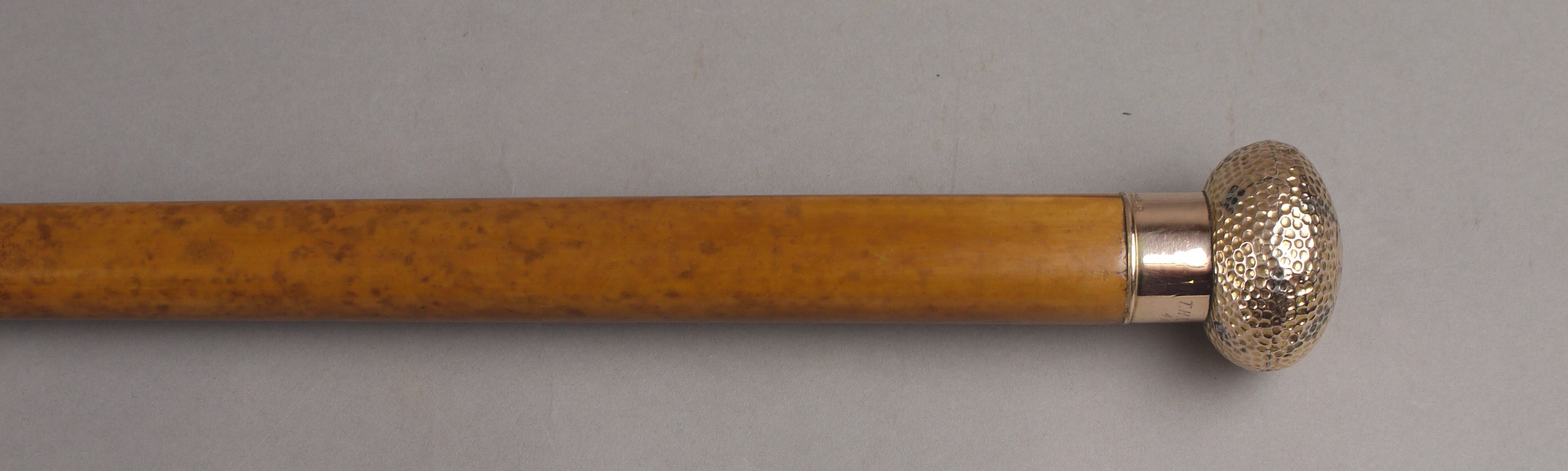 AN EDWARD VII MALACCA WALKING CANE, with a 9ct gold 'golf ball' knop, engraved with a monogram,