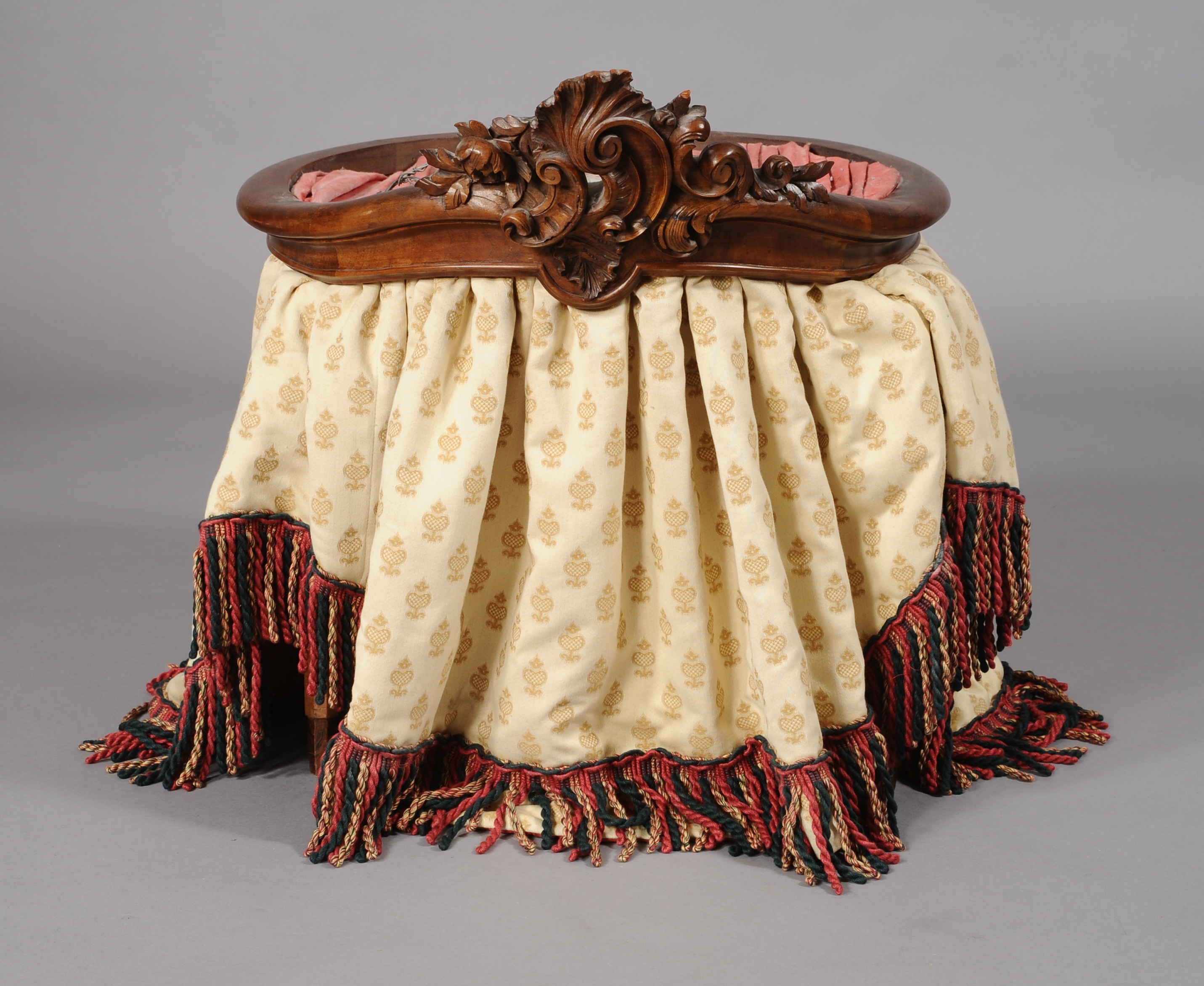 A 19TH CENTURY FRENCH WALNUT BED CANOPY, the circular moulded frame with foliate 'C' scroll and