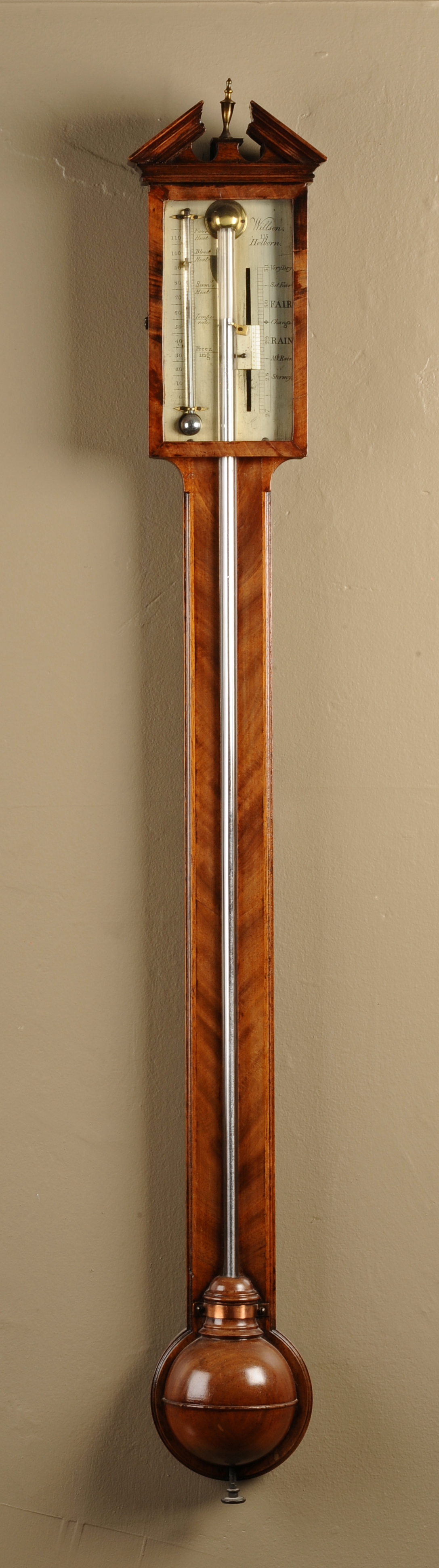 A GEORGE III MAHOGANY STICK BAROMETER, with an architectural pediment, the silvered register