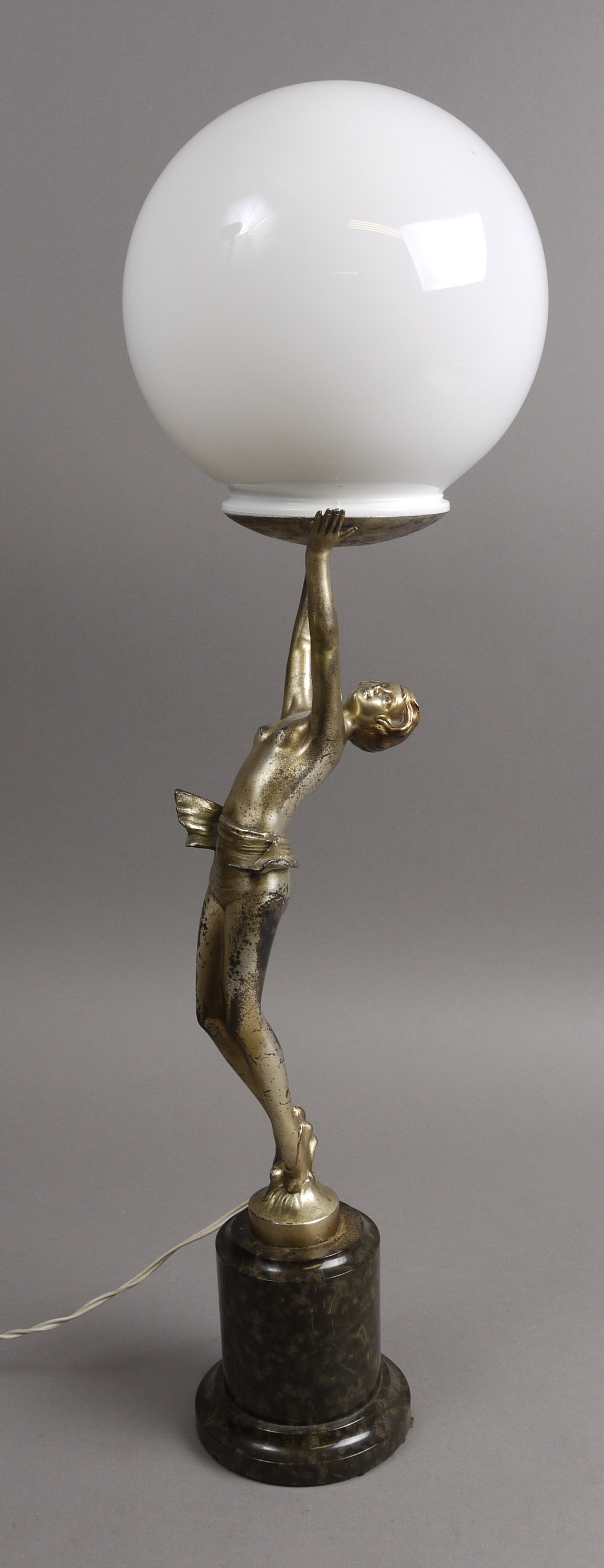 AN ART DECO SILVER PATINATED SPELTER TABLE LAMP, fashioned as a semi-nude female standing with