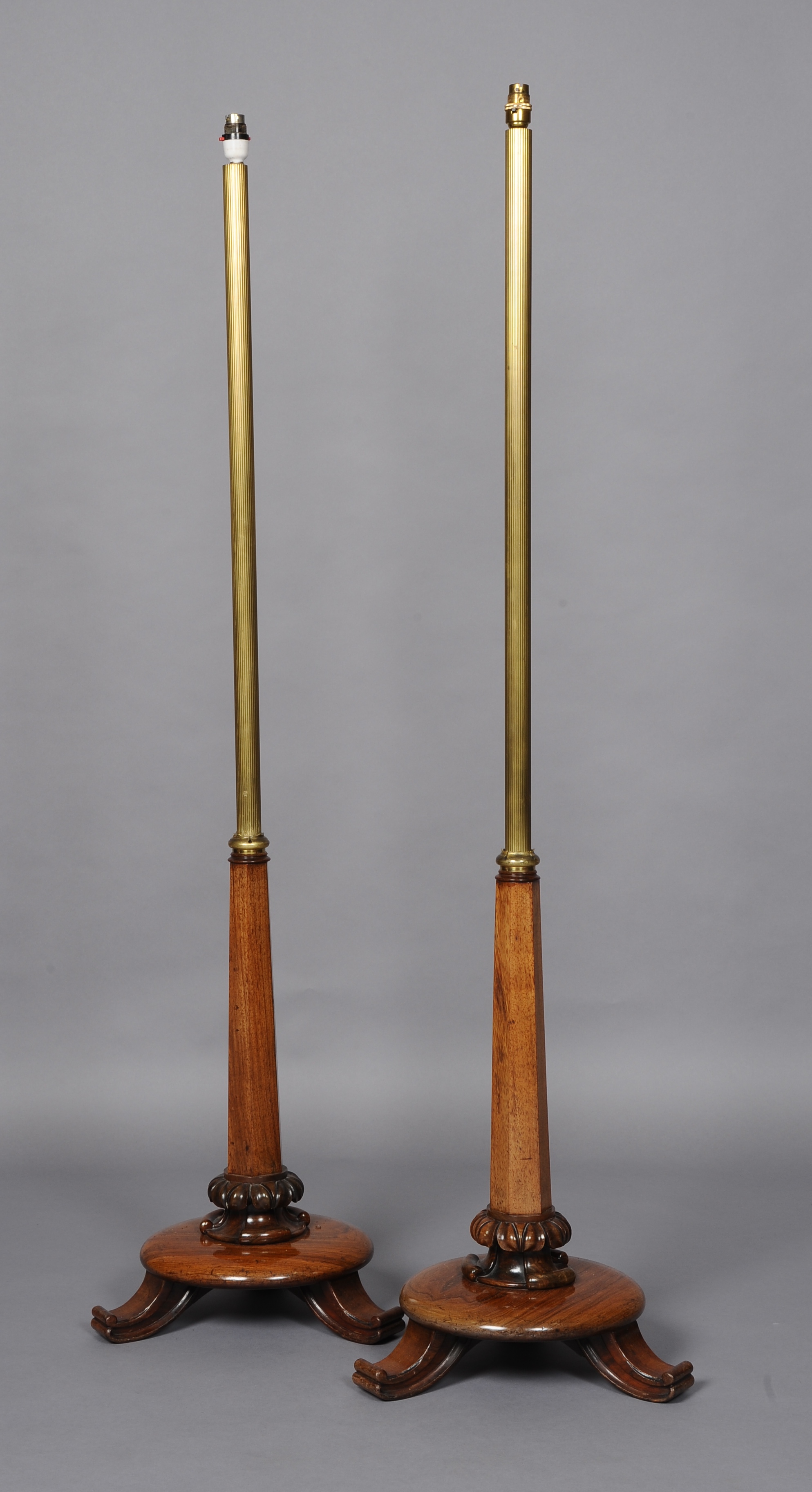 A PAIR OF REGENCY ROSEWOOD AND BRASS STANDARD LAMPS, now converted for electricity each with a