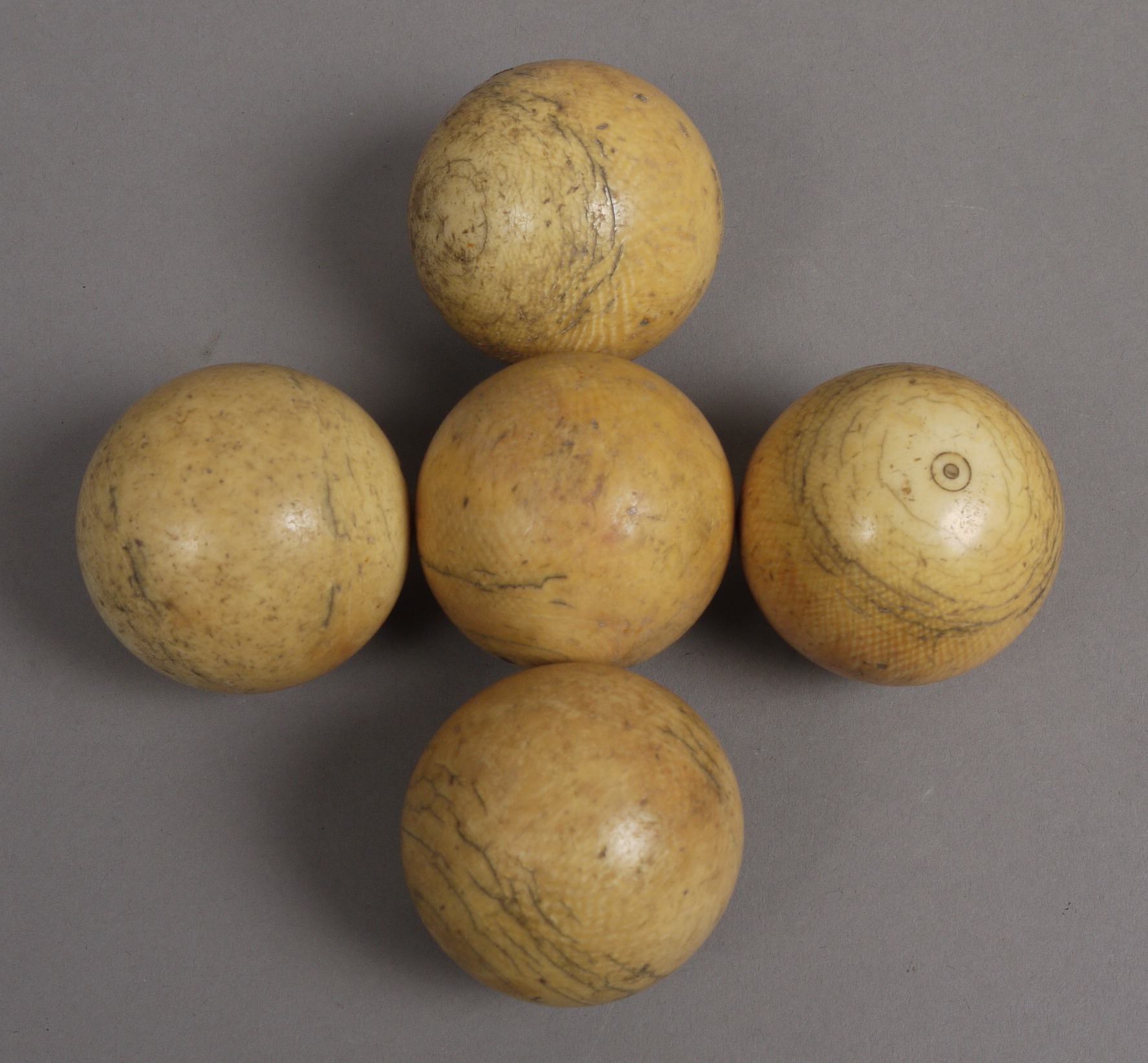 FIVE 19TH CENTURY WHITE IVORY BILLIARD BALLS, approximately 4.5cm diameter