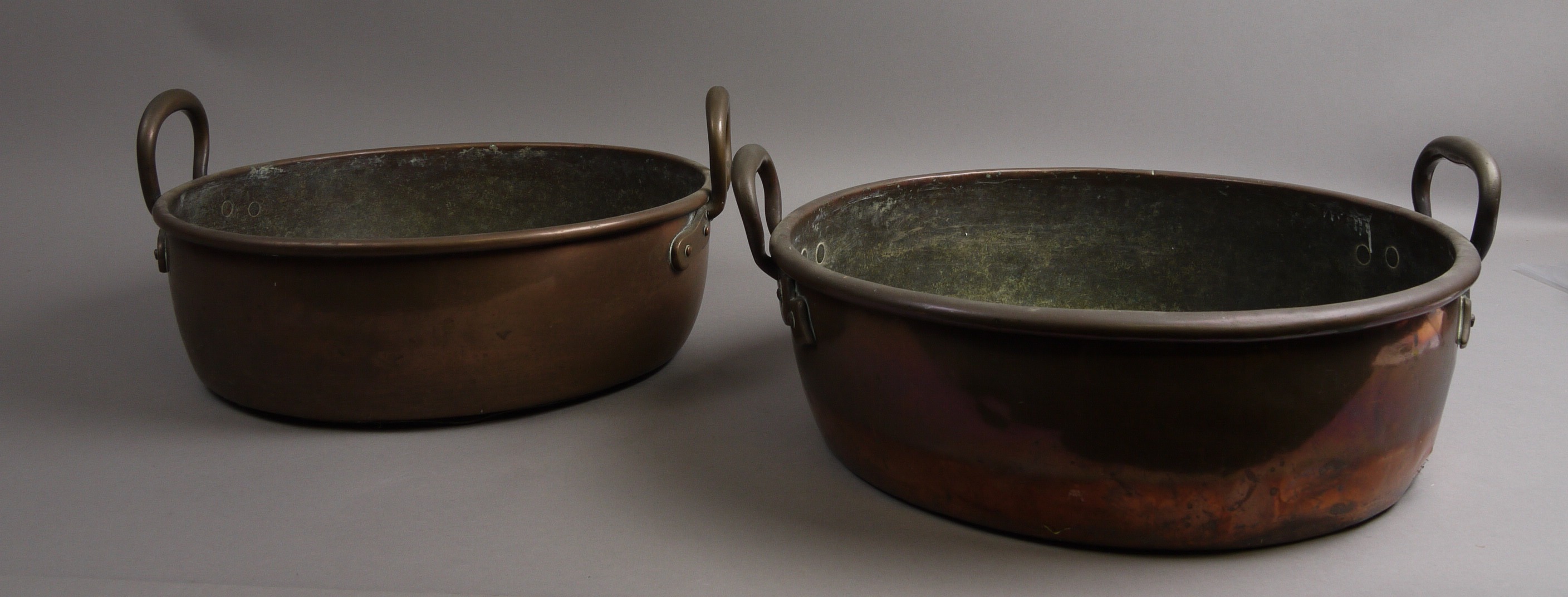 A VICTORIAN COPPER AND BRASS TWO-HANDLED SHALLOW SIMMERING PAN, 41cm diameter; and another