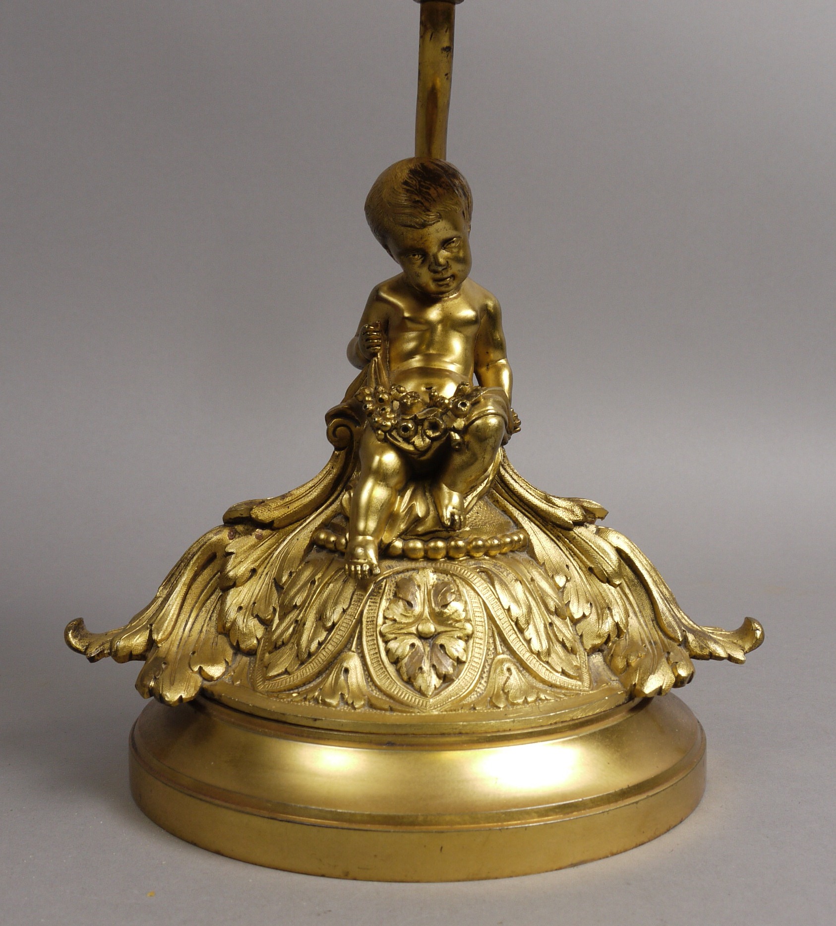 A 20TH CENTURY FRENCH ORMOLU TABLE LAMP, the domed circular base foliate cast and surmounted by a