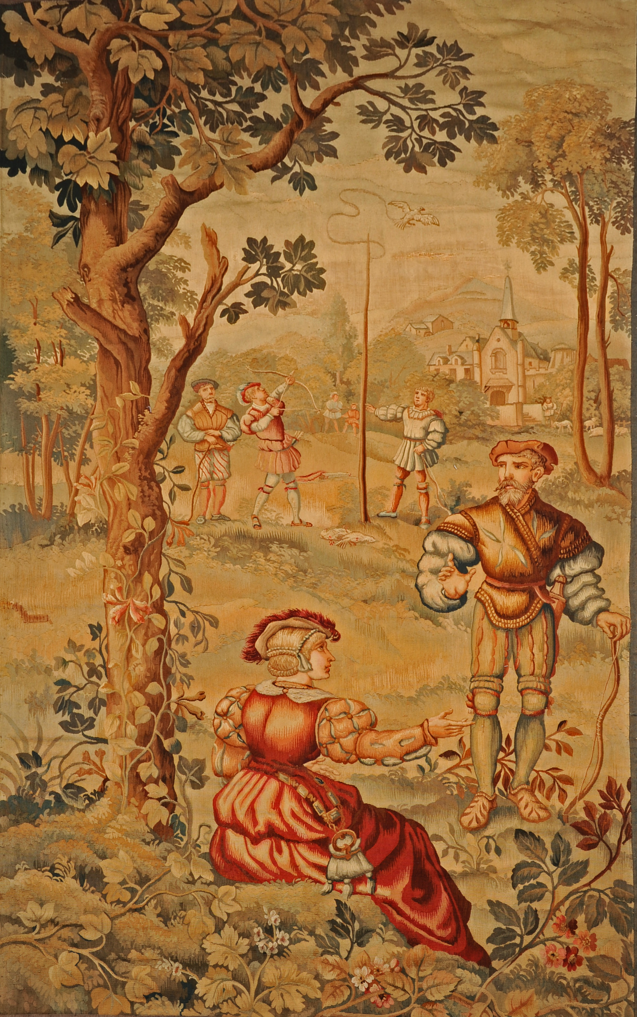 A 19TH CENTURY FLEMISH TAPESTRY PANEL, depicting a game of popinjay in a medieval landscape, 204cm x