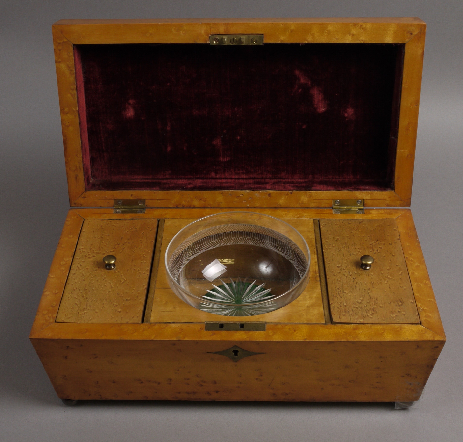 A MID 19TH CENTURY BIRDS EYE MAPLE TEA CADDY, of sarcophagus form, internally fitted with two lidded