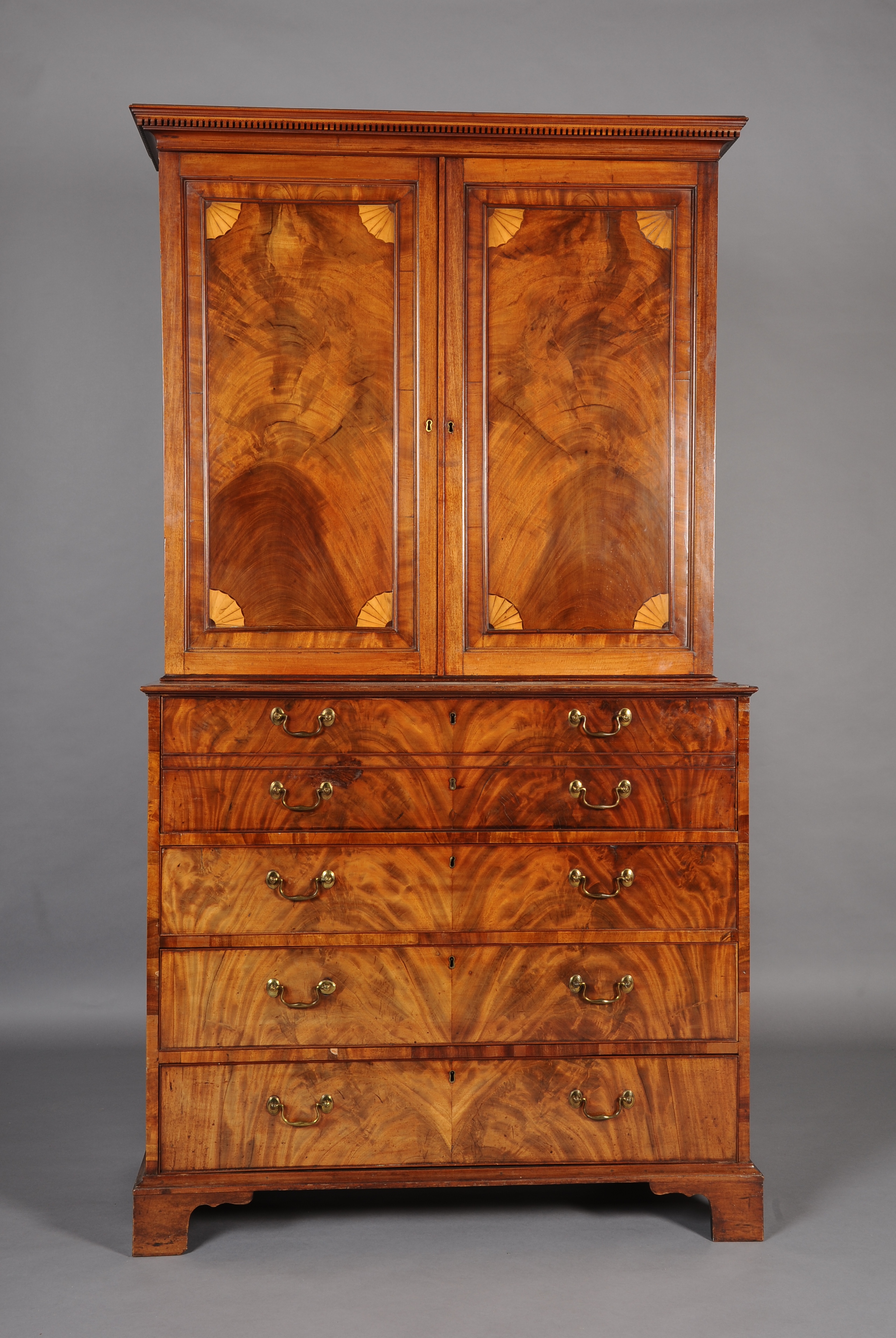 A GEORGE III FIGURED MAHOGANY SECRETAIRE BOOKCASE, the upper section with a dentil cornice over a