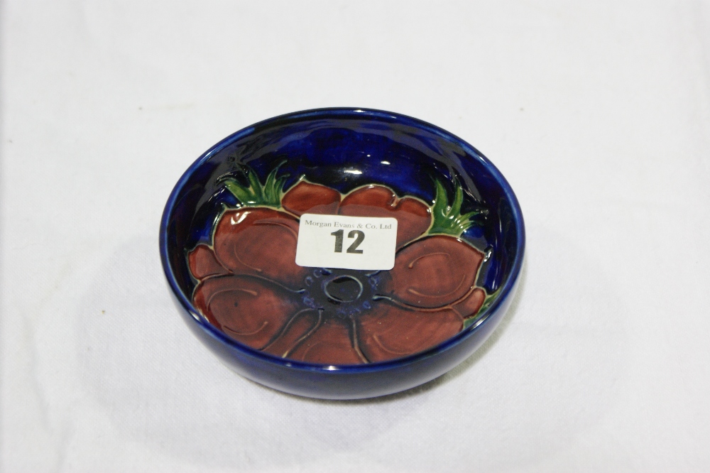 A Circular Blue Ground Moorcroft Pottery Dish With Floral Centre 4 1/2" Diameter