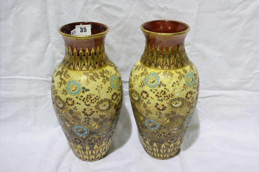 A Pair Of Doulton Slater’s Circular Based Stone Ware Vases With Floral Decoration, (Both AF) 12"