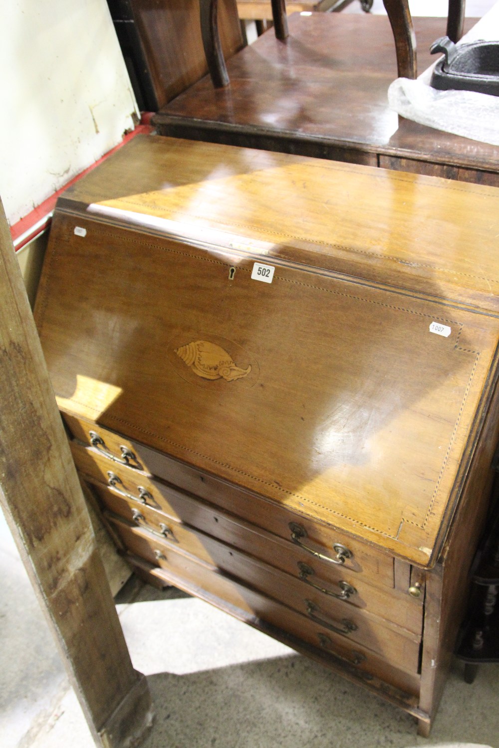 An Edwardian Mahogany And Inlaid Four Drawer Bureau