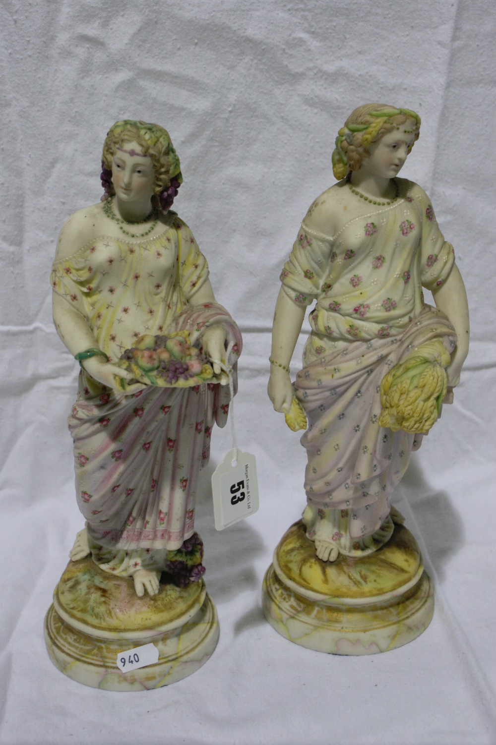 A Pair Of Late Victorian Bisque China Figures Of Classical Harvest Gatherers On Stylised Marble