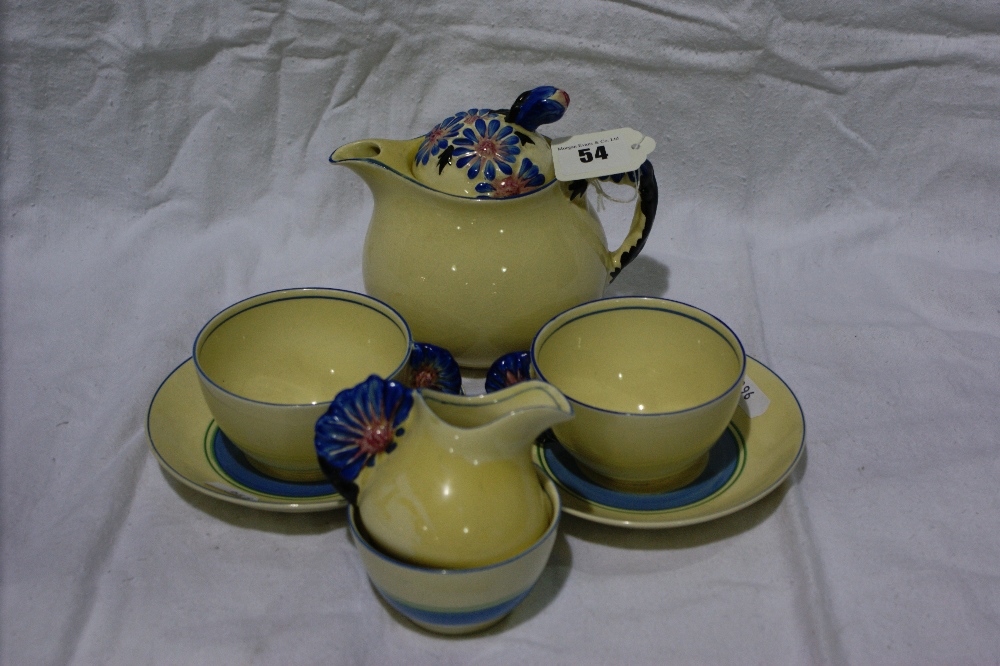 A Clarice Cliff Marguerite Pattern Three Piece Tea Service And Pair Of Cups And Saucers