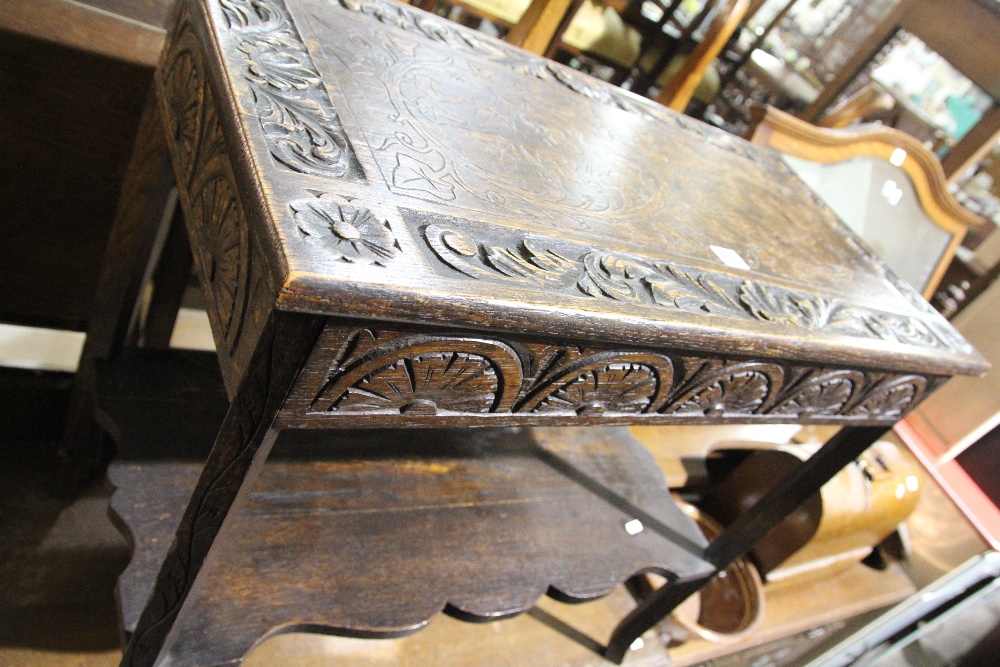 A Carved Oak Two Tier Occasional Table