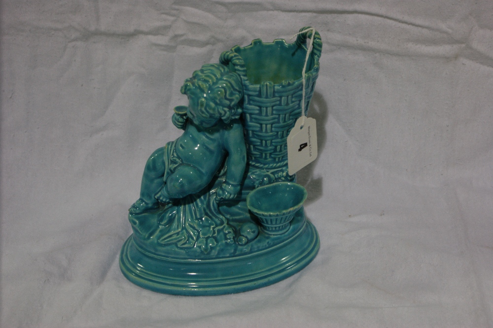 A Wedgwood Turquoise Glazed Pottery Posy Vase In The Form Of A Sleeping Cherub And Basket, Impressed