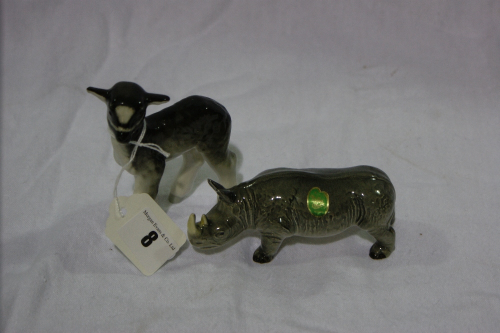 A Melba Ware Model Of A Rhinoceros Together With A Similar Model Of A Standing Lamb