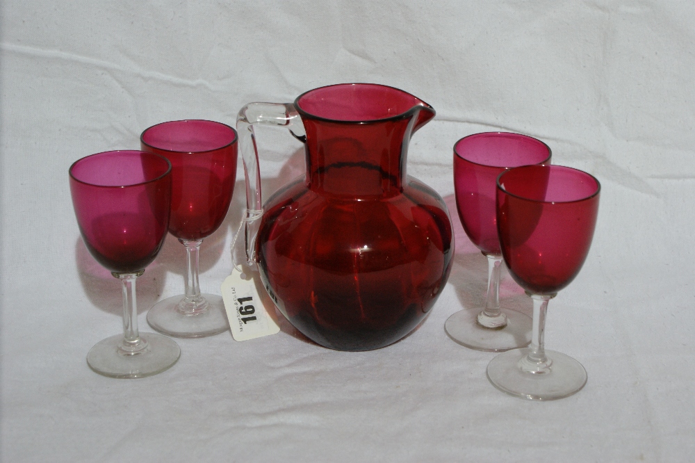 A Cranberry Tinted Water Jug And Four Glasses