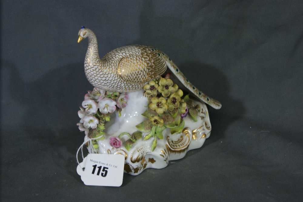 A Stevenson And Hancock Derby Model Peacock, The Bird Perched On A Flower Encrusted Branch