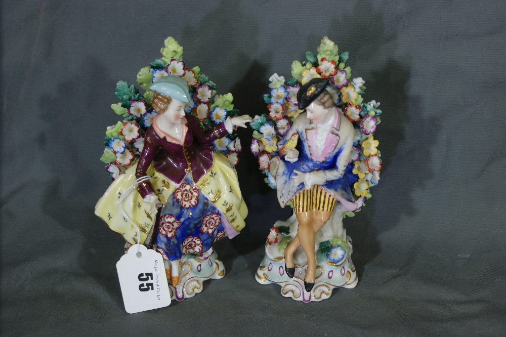 A Pair Of 19th Century China Bocage Figures In The Manner Of Derby, Modelled As Two Seated Country