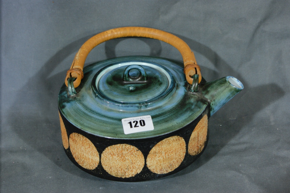 A Troika Pottery Tea Pot With Circular Pattern And Cane Handle