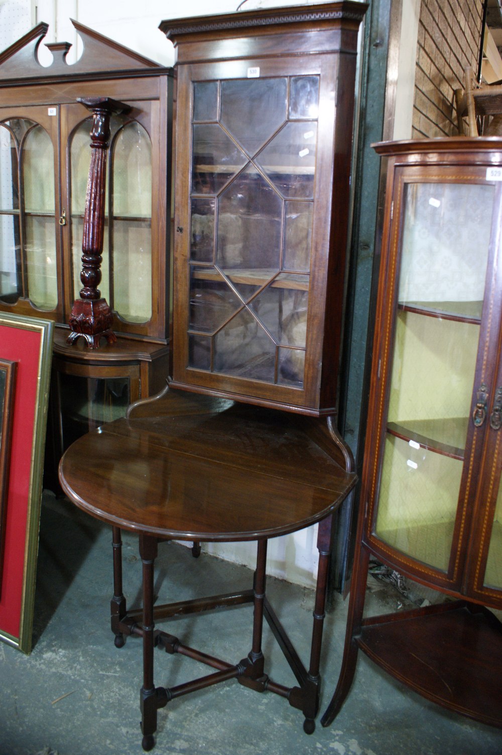 An Unusual Mahogany Cabinet Having A Drop Leaf Table Base And An Upper Portion Of Astrical Glazed