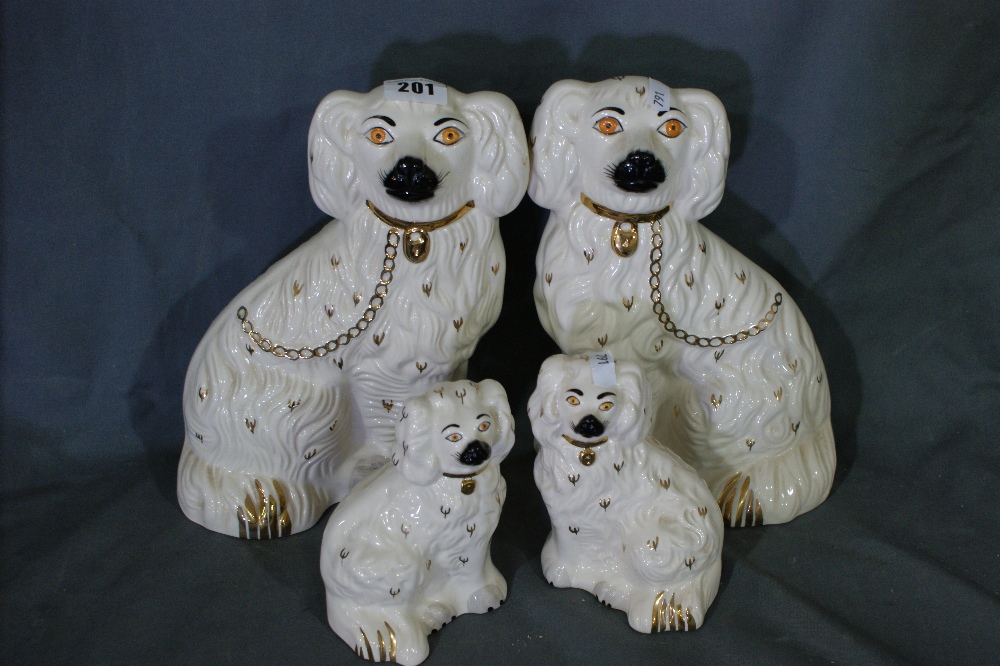 A Pair Of Royal Doulton Staffordshire Style Seated Dogs Together With A Similar Smaller Beswick Pair