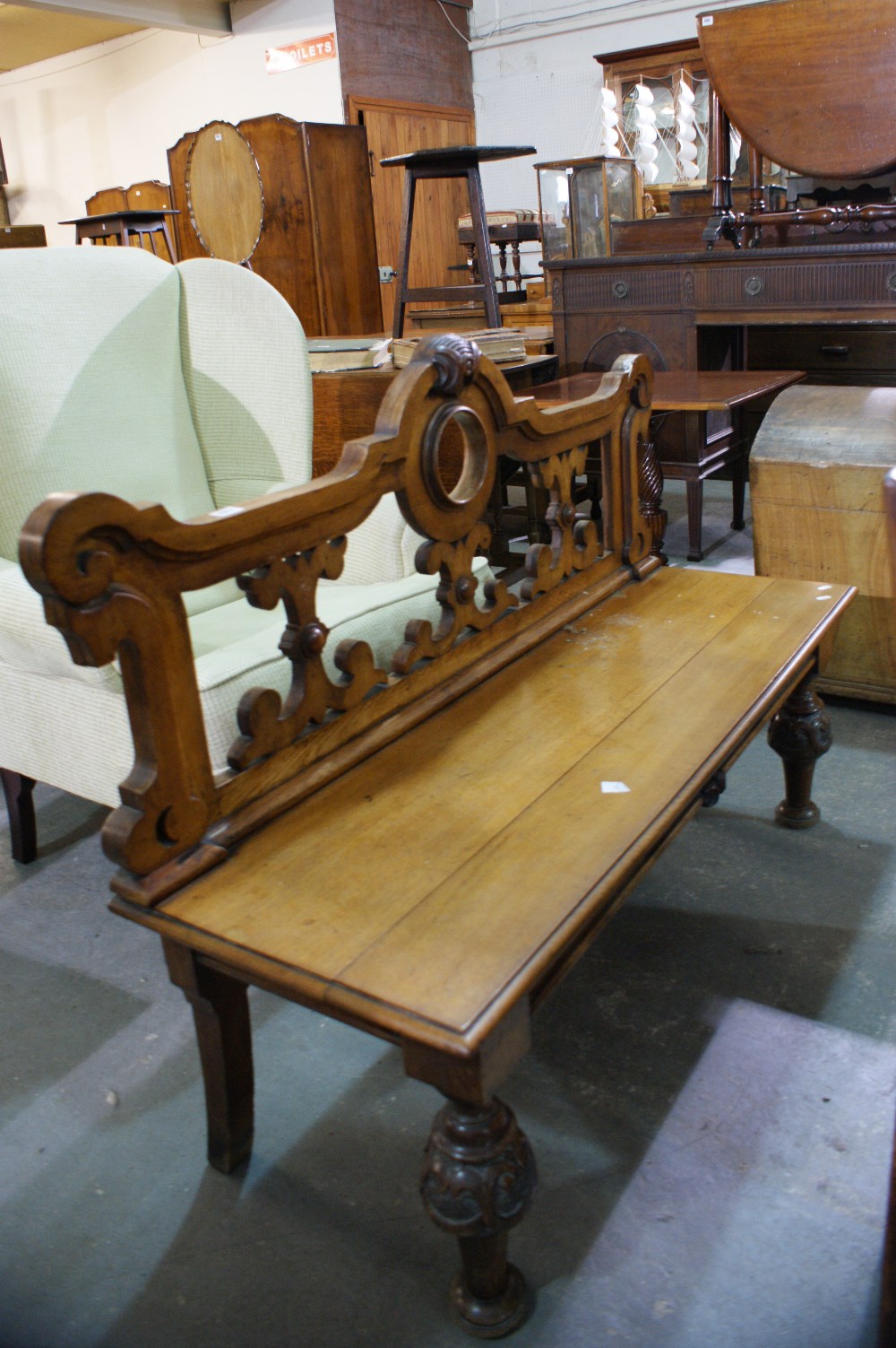 A Victorian Oak Bench With Ornate Carved Back And Turned Supports