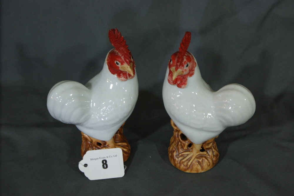 A Pair Of China Model Cockerels Standing On Circular Oriental Hardwood Plinths 7 ½” High