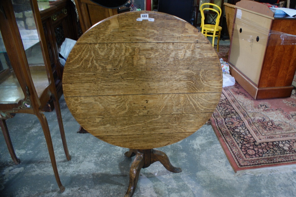 An Antique Oak Circular Topped Tripod Table