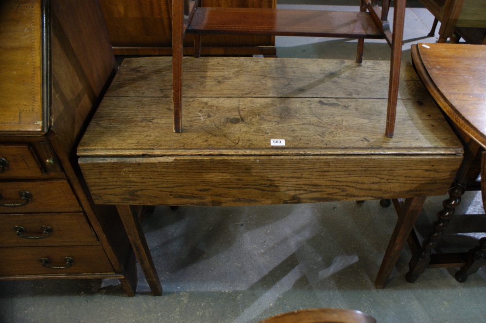 An Antique Oak Drop Leaf Table On Square Tapered Supports