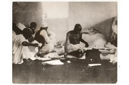 India – M K Gandhi – father of the Indian nation. Photograph of Gandhi at work spinning the Charka
