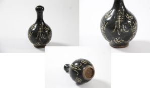 China – An unusual black Chinese Vase with character marks engraved on the actual vase.