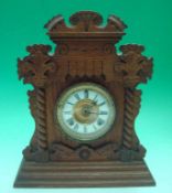 20th Century Oak Mantel Clock: Ornate carved case having roman numerals within a gilt surround,
