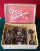 1950s Chad Valley Bakelite Telephones: Pair of Walnut effect telephones complete with wires housed