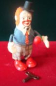 Schuco No.965 Clown Juggler: Scarce example with blue jacket and checked trousers, orange hair,