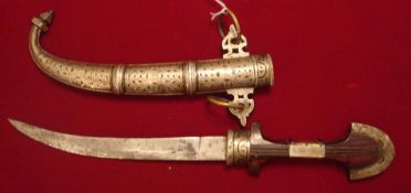 Far Eastern Dagger: Having a Wooden Handle with Brass and White metal construction and a curved