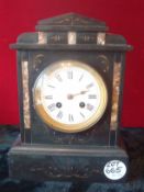 Marble Clock: Mantel clock having white enamel roman numeral face with ornate black marble case with