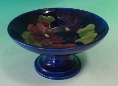 Walter Moorcroft Pedestal Bowl: Decorated with the `Clematis` pattern on a dark blue ground,