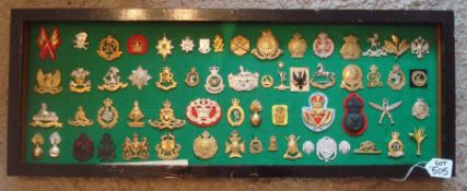 Selection of Military Badges: All mounted in a unglazed frame with green baize background 62 in