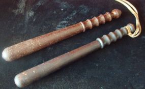 Two Police Truncheons: Un-painted with ribbed grip. One having leather strap 40cm Condition Worn (2)