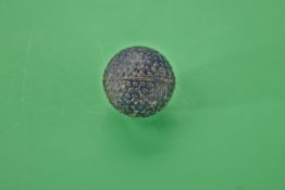 A small bramble pattern gutty golf ball c1890 – black finish, used, no strike marks, good shape