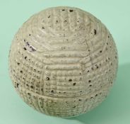 A rare Forgan-style hand hammered gutty golf ball c1880 with hand hammer marks around each pole