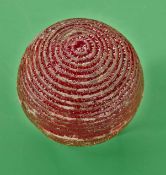 A large red concentric circle rubber core golf ball c1900 – retaining good shape, colour, no